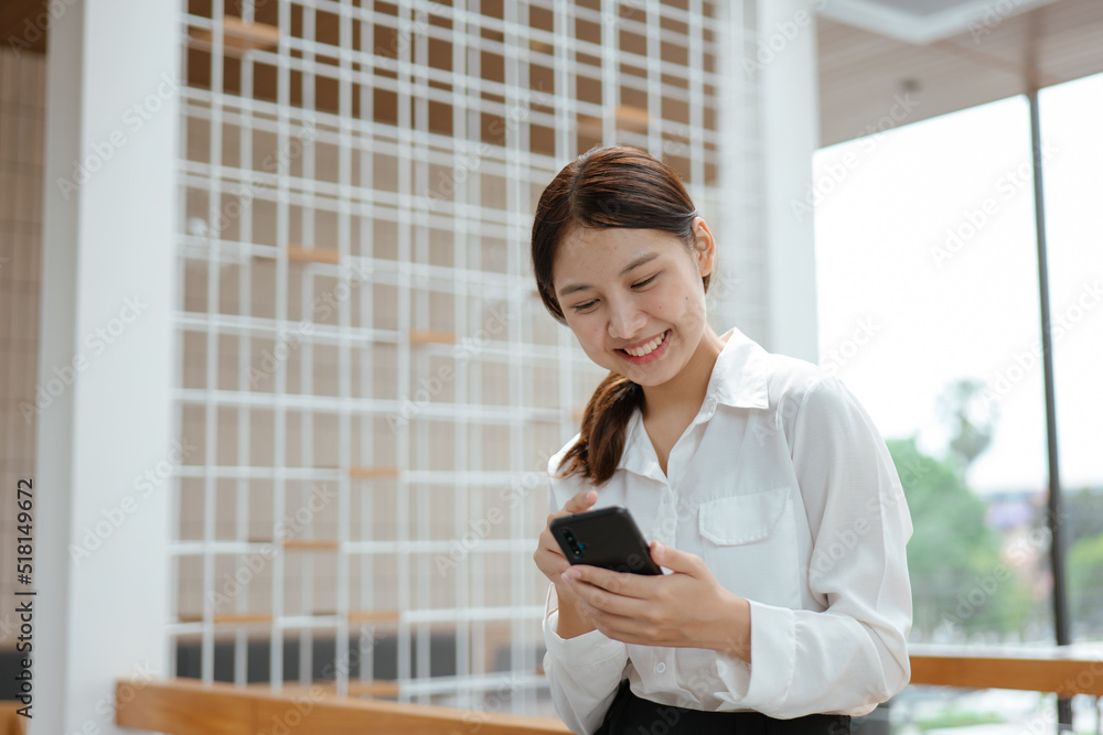 Business woman working on smartphone in office space. Business woman working on smartphone in office space.
