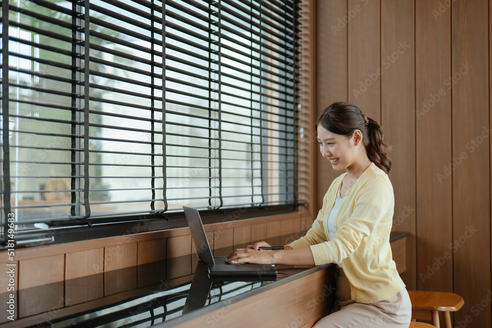 Young business women working and typing on laptop with happy and smile face on office spec. Young business women working and typing on laptop with happy and smile face on office spec.
