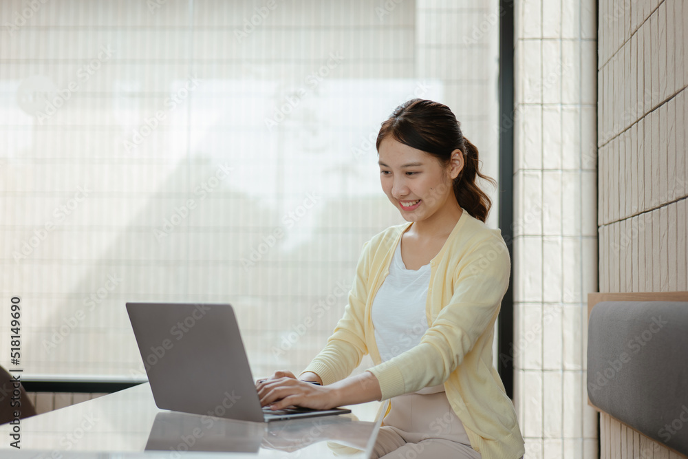 Young business women working and typing on laptop with happy and smile face on office spec. Young business women working and typing on laptop with happy and smile face on office spec.