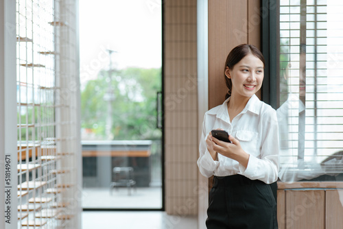 Business woman working on smartphone in office space.