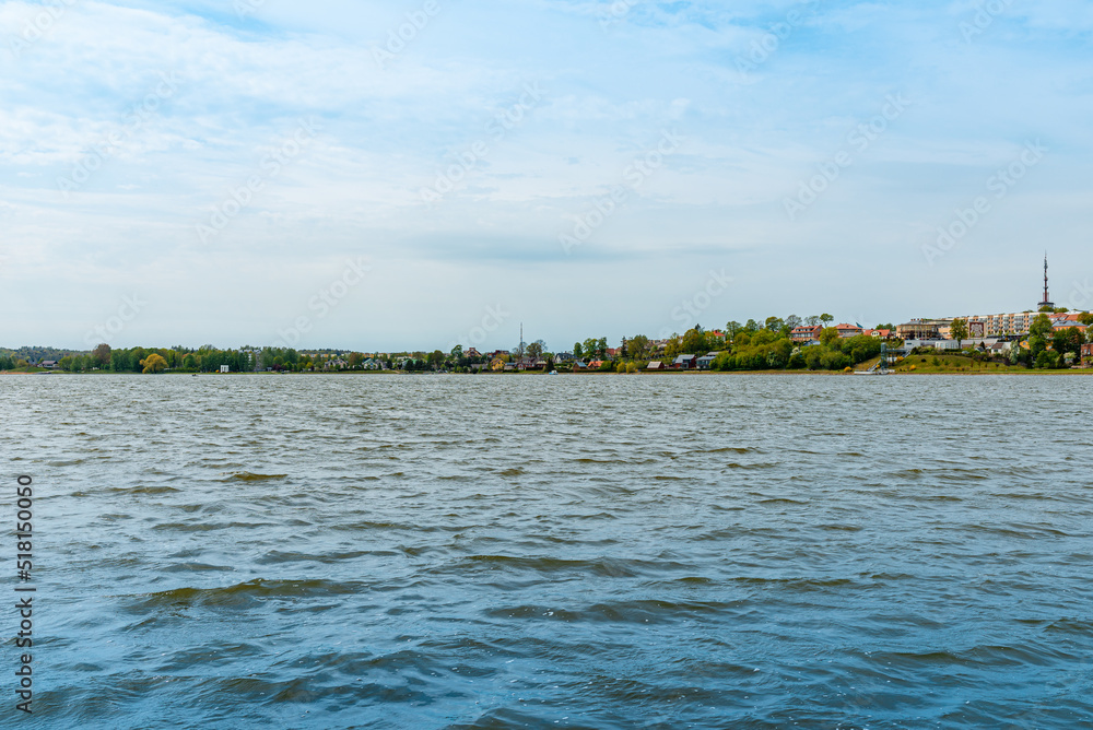 Beautiful summer panorama of Lithuania city Telsiai with cloudy sky, View over the lake Mastis to the city.