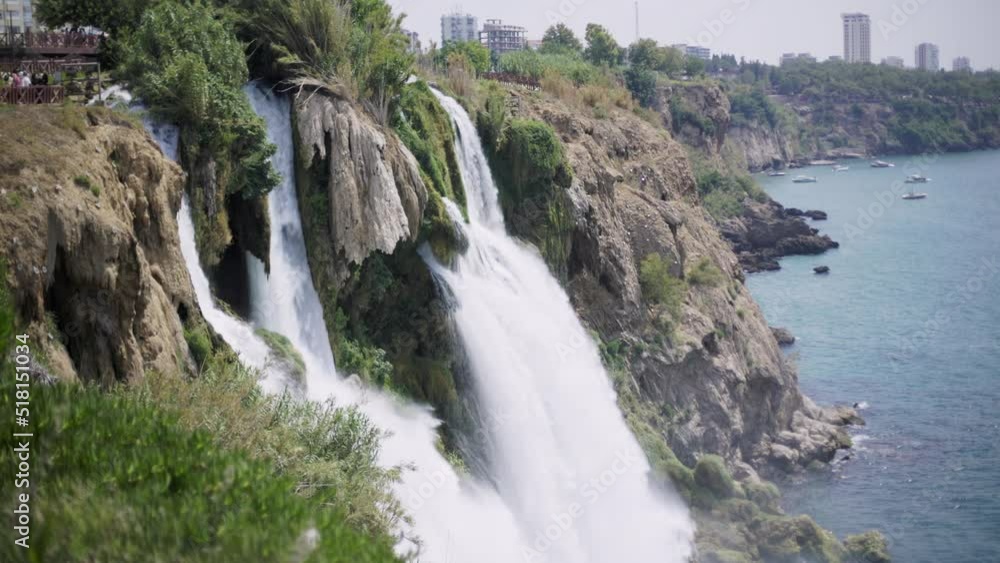 Duden waterfall in the Duden park on the Mediterranean coast in Antalya, Turkey. View of seascape, azure sea and steep rock on a sunny day. Duden waterfall in the Duden park on the Mediterranean coast in Antalya, Turkey. View of seascape, azure sea and steep rock on a sunny day.