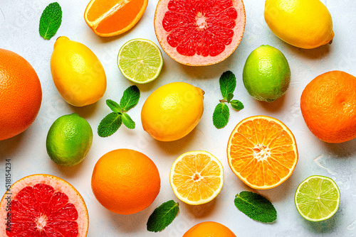 Fototapeta Naklejka Na Ścianę i Meble -  Fresh lemon, orange, grapefruit, lime, green leaves on light background, top view.