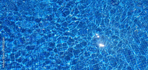 Clean water in the pool. Blue water in the pool. Clear water in the pool. Swimming pool background.