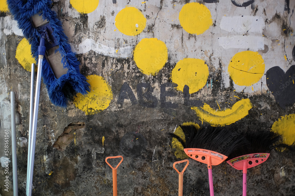 Cleaning equipment mops and broom fibers are placed upside down on the