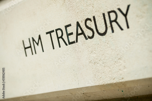 Angled view of HM TREASURY sign on Whitehall building in London, UK.