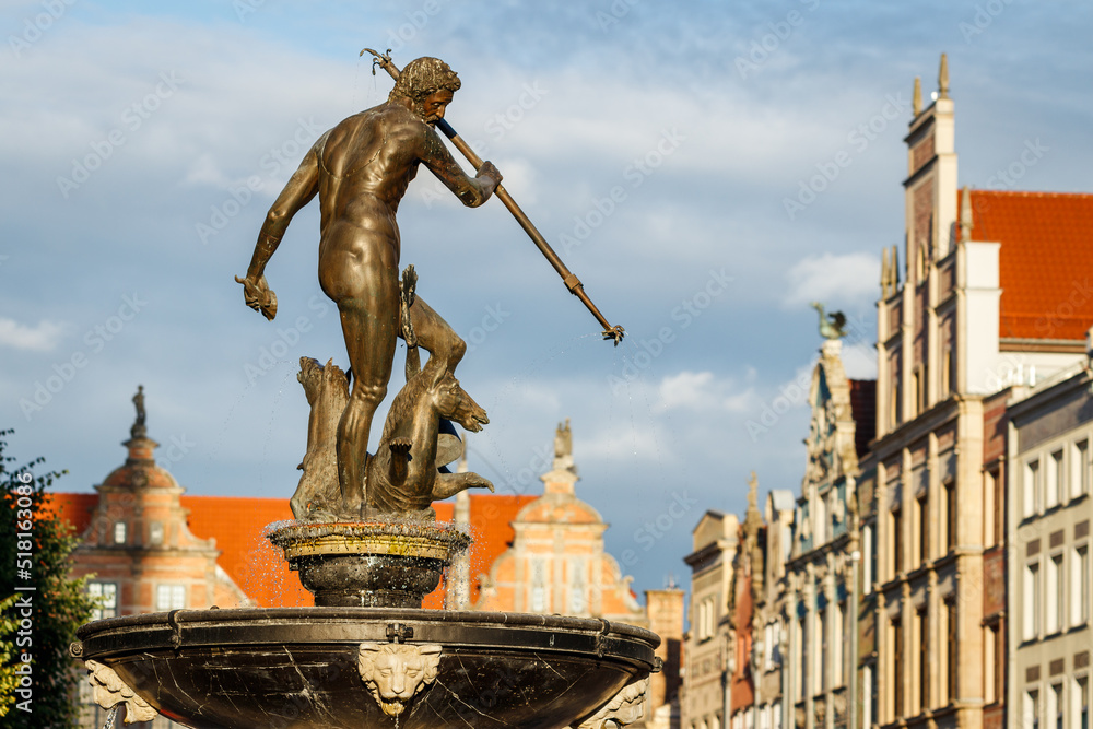 Obraz premium Gdansk, Poland with Neptune fountaine statue. Famous place and tourist attraction in travel destination. European old town at Baltic sea