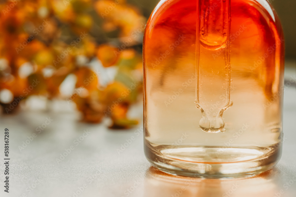 Natural cosmetics, serum in a bottle with a close-up. Spa and bio autumn skincare concept Natural cosmetics, serum in a bottle with a close-up. Spa and bio autumn skincare concept