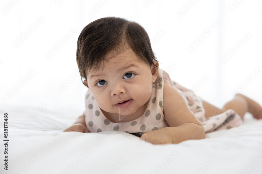 cute baby crawling on bed and drooling from mouth cute baby crawling on bed and drooling from mouth