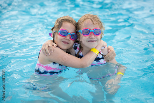 Lovely smiling children in swimming pool wearing diving goggles © Zsolt Biczó
