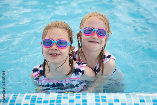 Lovely smiling children in swimming pool wearing diving goggles © Zsolt Biczó