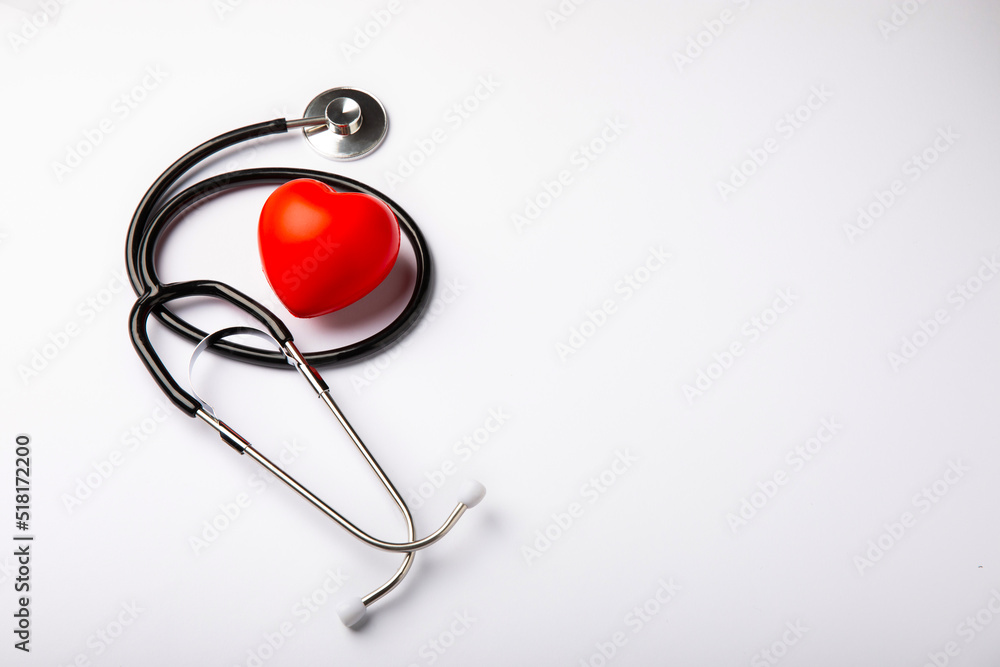 Stethoscope and red decorative heart isolated on white background.flat lay.place for text. The concept of cardiology. Stethoscope and red decorative heart isolated on white background.flat lay.place for text. The concept of cardiology.