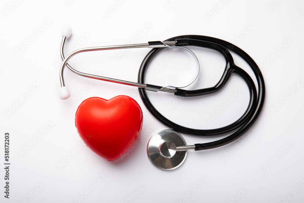 Stethoscope and red decorative heart isolated on white background.flat lay.place for text. The concept of cardiology. Stethoscope and red decorative heart isolated on white background.flat lay.place for text. The concept of cardiology.