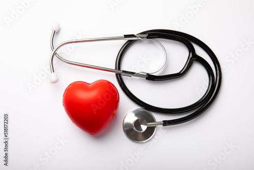 Stethoscope and red decorative heart isolated on white background.flat lay.place for text. The concept of cardiology.