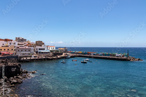 Panoramic view on small fishermen coastal village Los Abrigos, Tenerife, Canary Islands, Spain, Europe, EU. Coastline of Atlantic Ocean. Small boats floating in the turquoise water of the marina