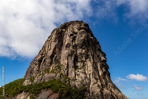 Scenic view on massive volcanic rock formation Roque de Agando in Garajonay National Park on La Gomera, Canary Islands, Spain, Europe. Lava cone of an old volcano. Hiking trail on sunny day in summer