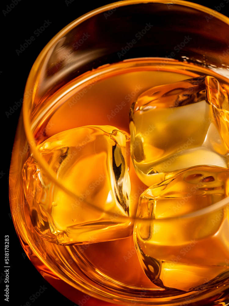 Whisky on the rocks, glass filled with ice cubes