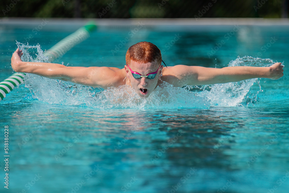 Young male athlete swimming butterfly