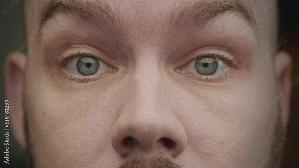 Close-up eyes of an adult caucasian man surprised with his eyebrows pulling up Close-up eyes of an adult caucasian man surprised with his eyebrows pulling up