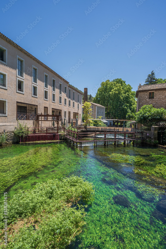 The natural landscape with green trees and river of the famous travel destination, Fontaine-de-Vaucluse, a small town in Provence, France