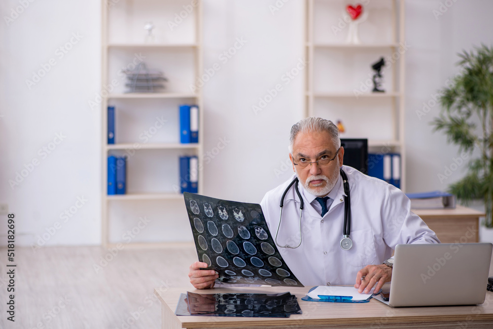 Old male doctor radiologist working in the clinic Old male doctor radiologist working in the clinic