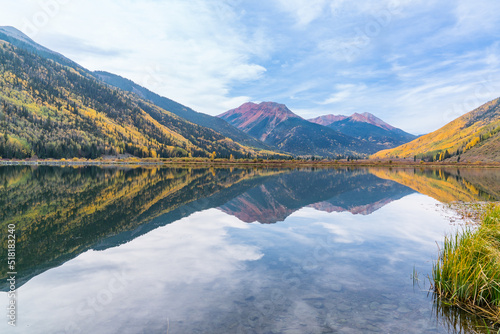 Reflection of autumn aspen trees along Crystal Lake along Red Mountain pass in the San Juan Mountains of Colorado