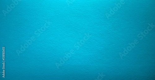 Photo of the turquoise background texture. Soft felt fabric of the color of the sea wave. A clean background for the text. Blue background for banner-shaped text.The color of the sea.