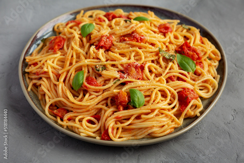 Homemade Spaghetti with Tomato Sauce on a Plate on a gray background, side view.
