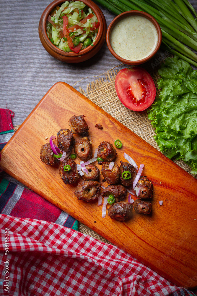 Barbecue chicken wings close up on wooden tray, shot with selective focus Barbecue chicken wings close up on wooden tray, shot with selective focus