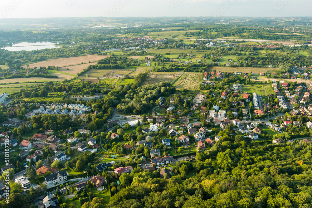 Aerial top view of suburb area with nice houses and cars on sunny summer day in Krakow, Poland.