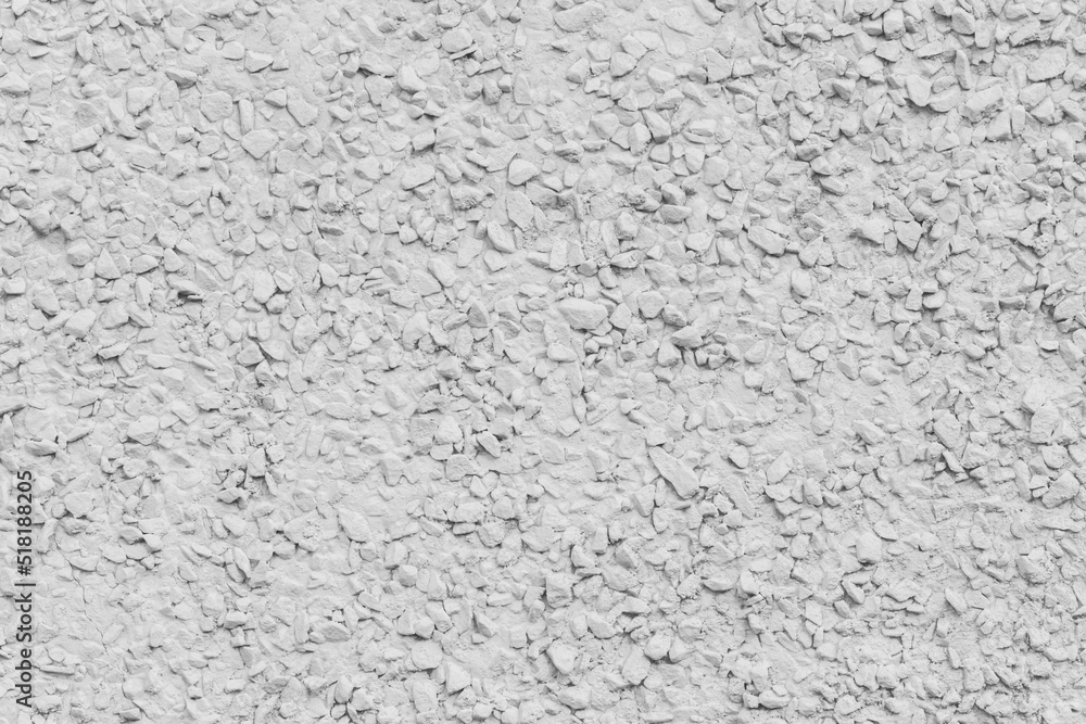 White paint on stone pebble surface solid texture wall background White paint on stone pebble surface solid texture wall background