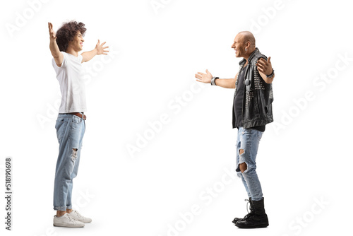 Full length profile shot of a young man meeting a punk with arms wide open