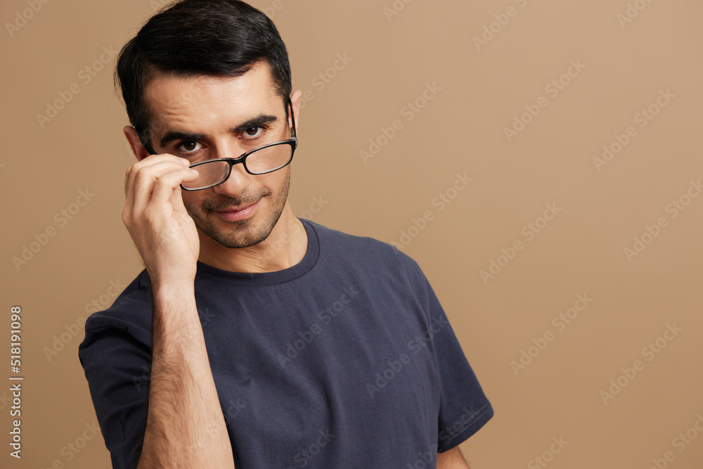 Cheerful man gray t-shirt glasses cropped view emotions beige background Cheerful man gray t-shirt glasses cropped view emotions beige background