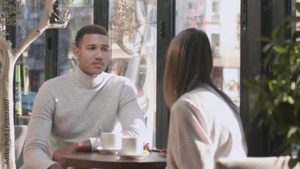 Friends in a restaurant talking smiling and drinking tea. Business colleagues having a meeting after work or during coffee break at a cafe bar.. Friends in a restaurant talking smiling and drinking tea. Business colleagues having a meeting after work or during coffee break at a cafe bar..