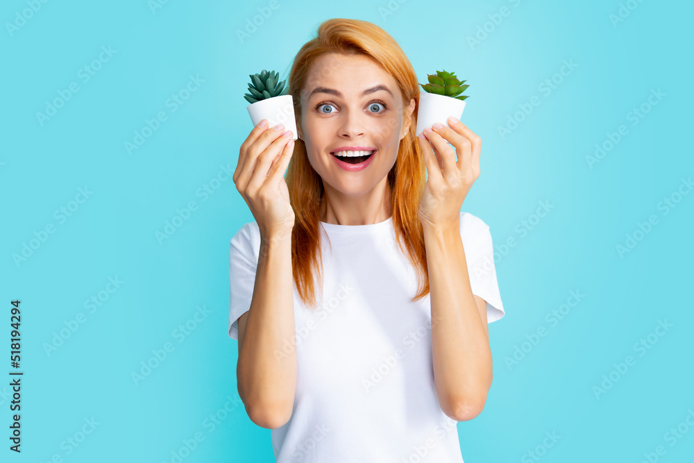 Emotional funny cute woman girl with a small cactus. Closeup face portrait isolated on blue background. Emotional funny cute woman girl with a small cactus. Closeup face portrait isolated on blue background.