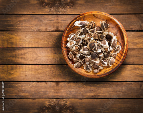Moringa oleifera - Organic moringa seeds in the wooden bowl