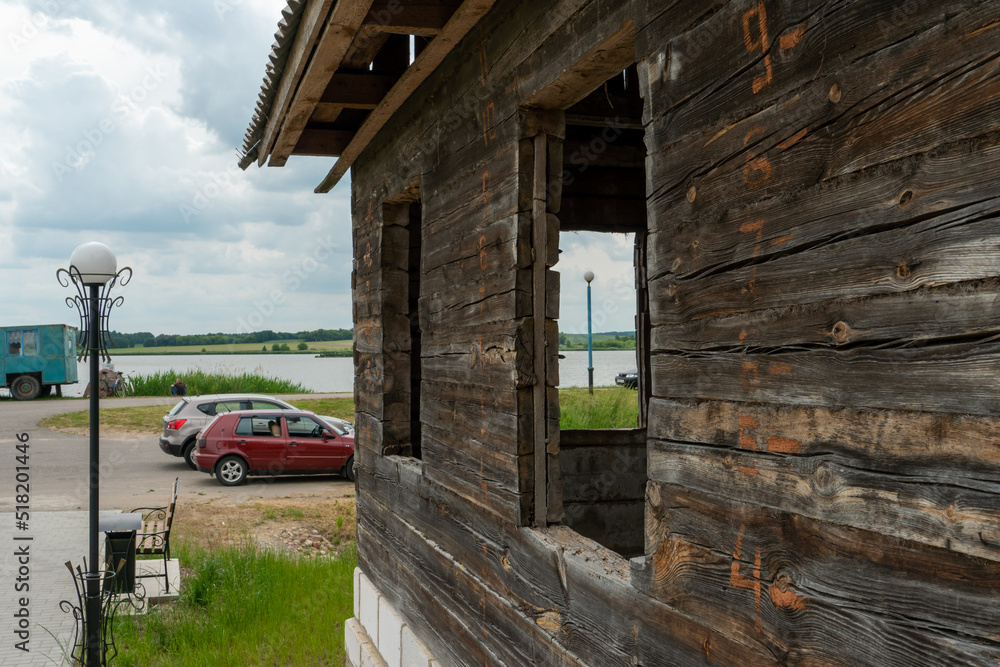 An old wooden house on a new modern foundation. Restoration and repair of a wooden house in the village. An old wooden house on a new modern foundation. Restoration and repair of a wooden house in the village.