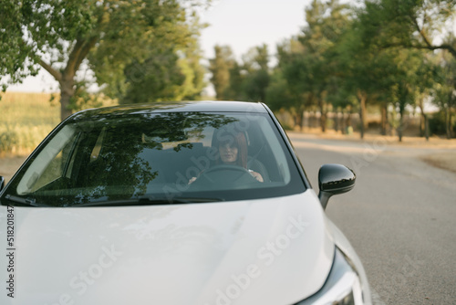 woman stopping the car on the road shoulder