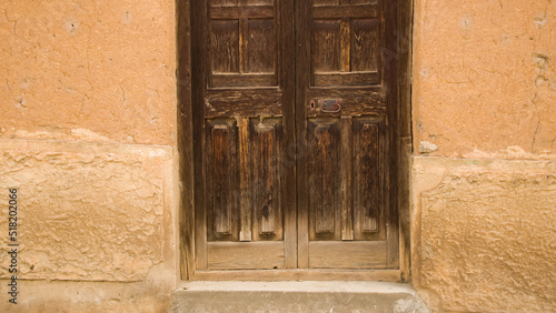Rustic Wooden door and adobe wall in huancaya, Lima Peru photo