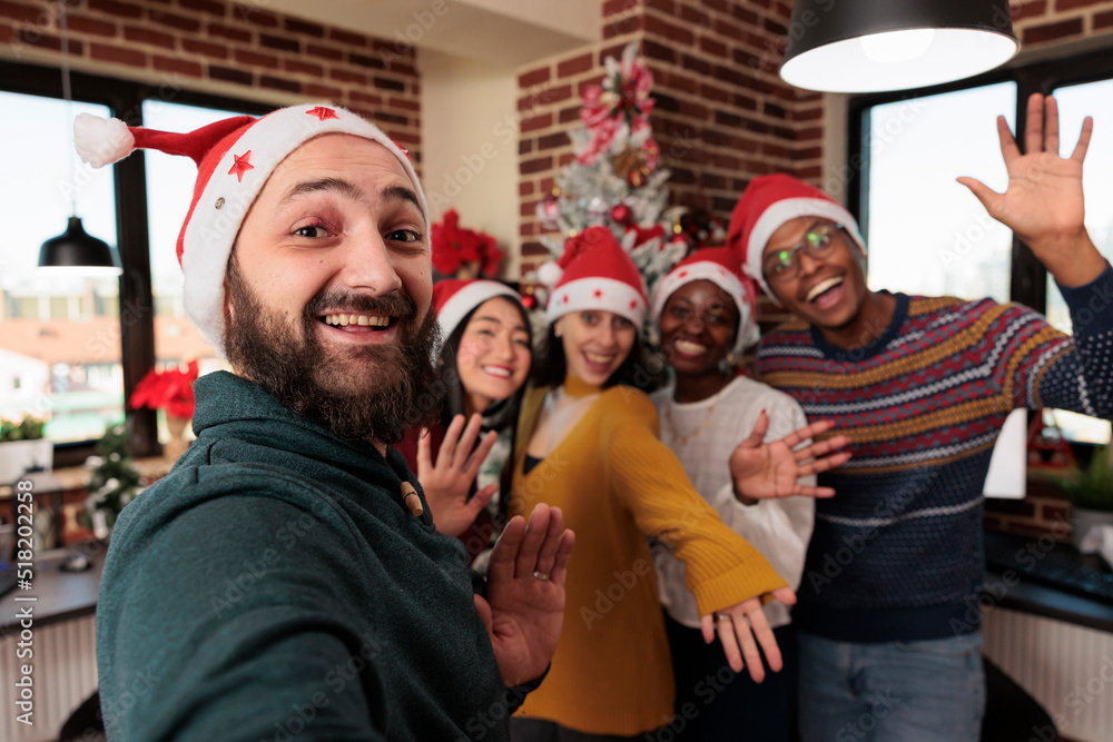 Diverse group of people taking pictures with christmas tree, celebrating festive season with holiday decorations in business office. Colleagues taking photos with seasonal xmas ornaments. Diverse group of people taking pictures with christmas tree, celebrating festive season with holiday decorations in business office. Colleagues taking photos with seasonal xmas ornaments.