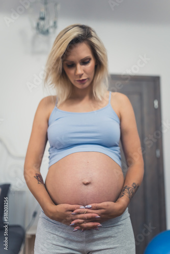 Free Download vertical medium shot of a blond pregnant woman at home. High quality photo - GFXLoad