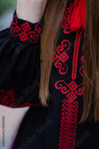 close up of national traditional ukrainian clothes. details of woman in embroidered dress. unrecognizable person
