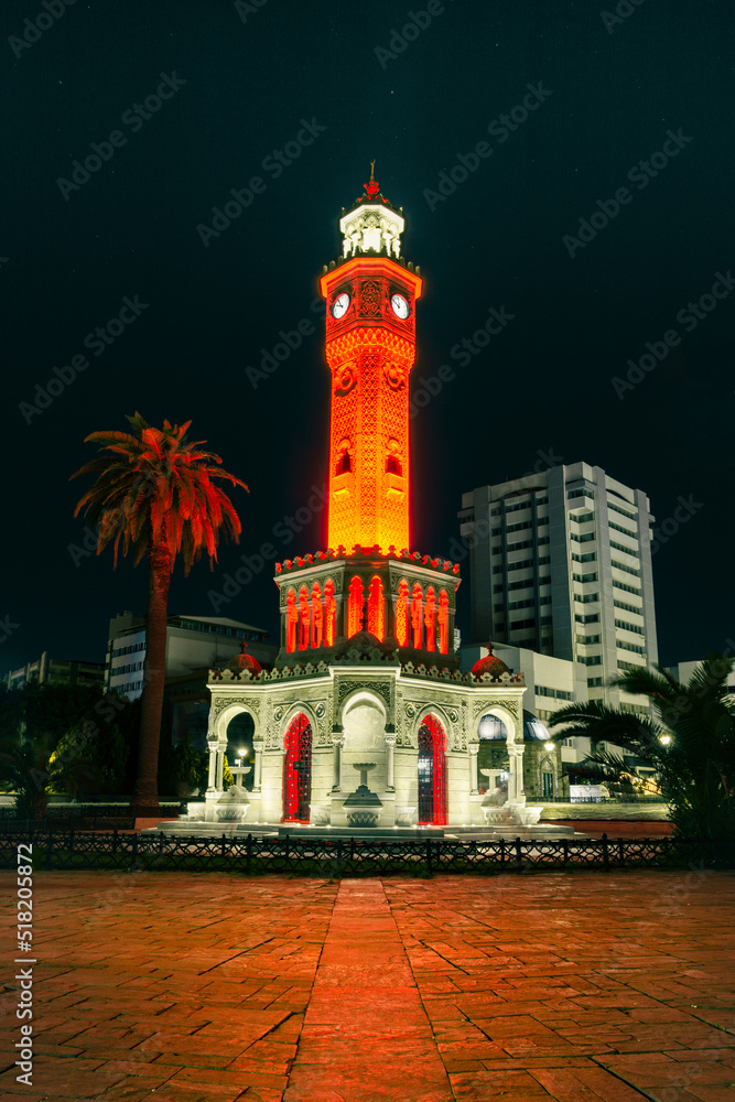 Night shot of Izmir watch tower with beautiful red and orange lighting on the tower.