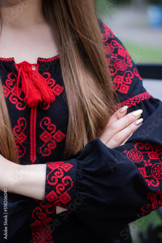 close up of national traditional ukrainian clothes. details of woman in embroidered dress. unrecognizable person
