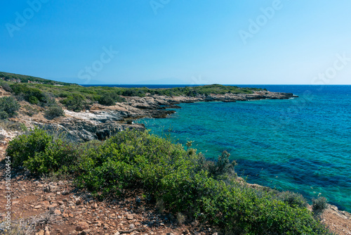 Amazing shot of a sea coast with clear blue water and stones in the foreground. © Vahid
