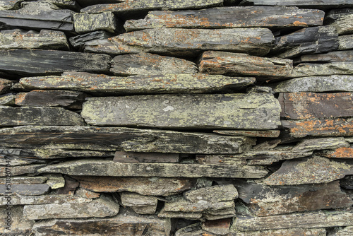 stone wall background from weathered slate stones