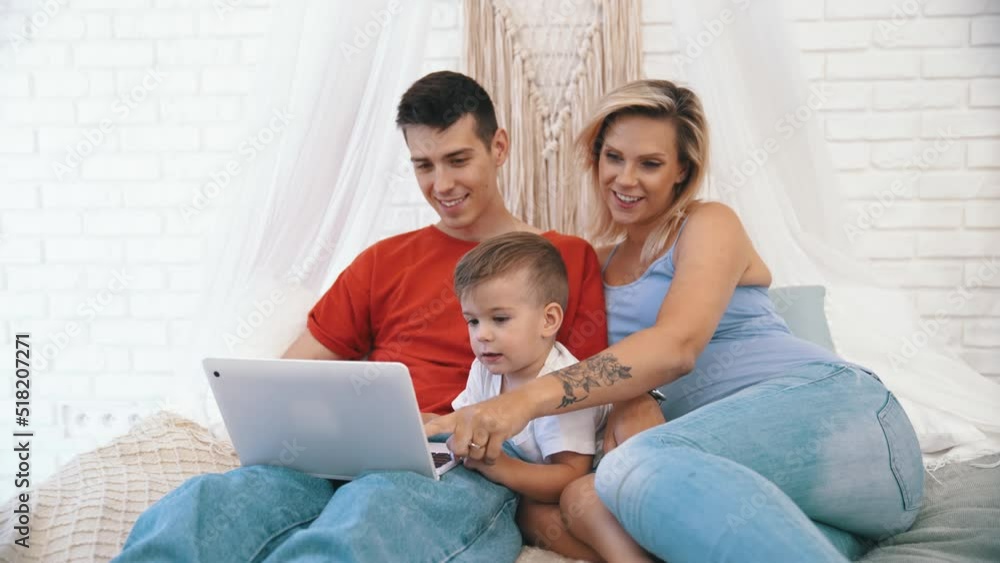 father, pregnant mother and little son watching something on the laptop. High quality 4k footage father, pregnant mother and little son watching something on the laptop. High quality 4k footage