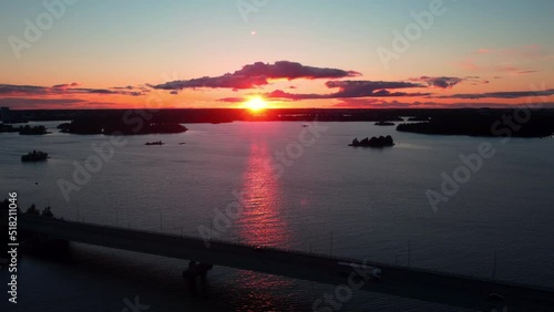 Traffic on a bridge, in Helsinki, summer sunset in Finland - rotating, pull back aerial  photo