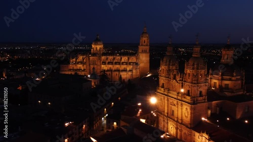Cinematic aerial drone video of the Salamanca cathedral lit up at night photo