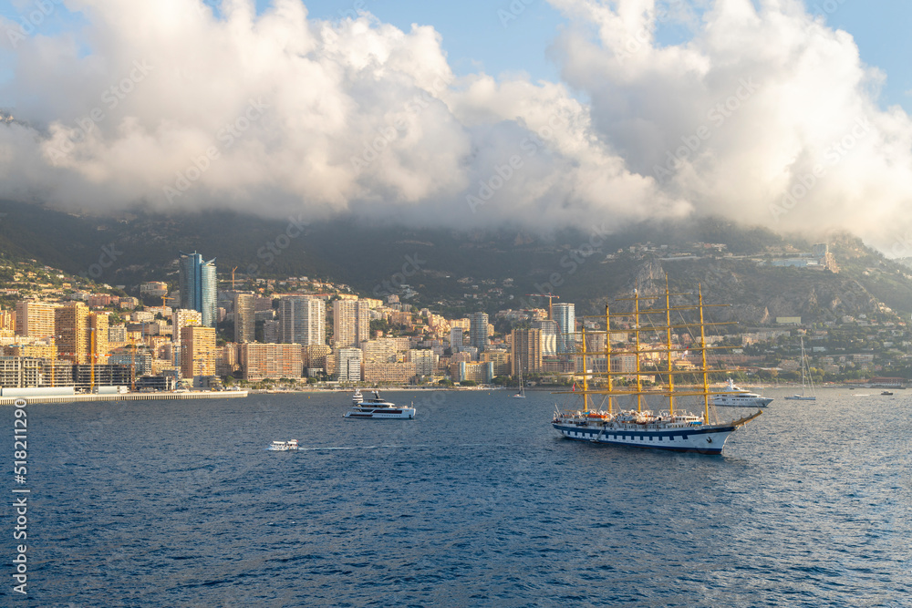 View from the sea as a schooner floats alongside luxury yachts early morning as the fog lifts in the harbor of Monte Carlo, Monaco.
